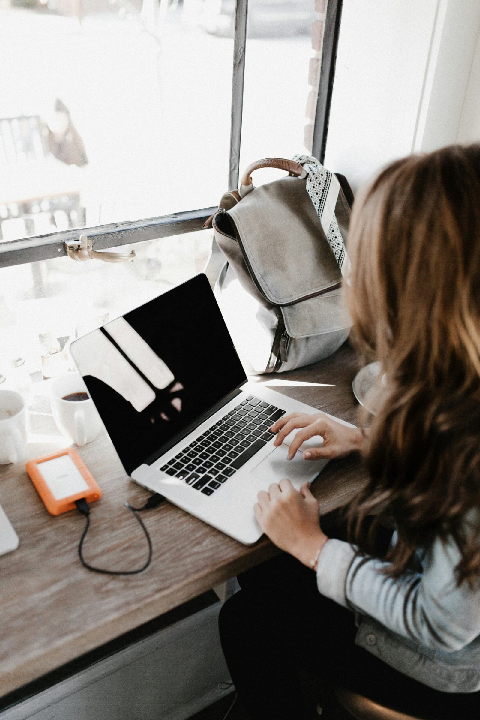 Crafting a Creative Resume in Microsoft Word: A Step-by-Step Guide 1 girl wearing grey long-sleeved shirt using MacBook Pro on brown wooden table